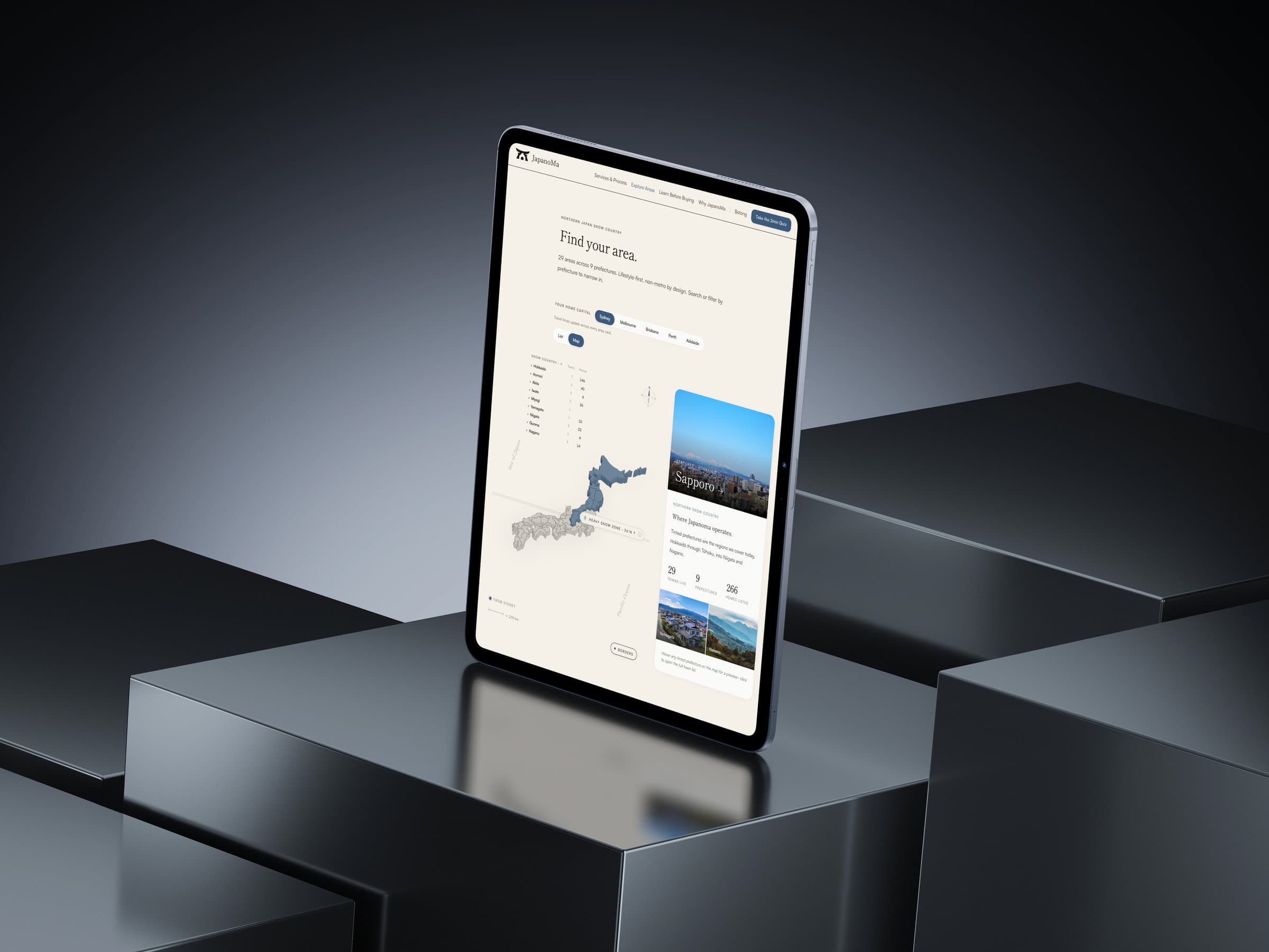 The 'Find your area' map of Japan on an iPad standing on a dark block, with Sapporo featured