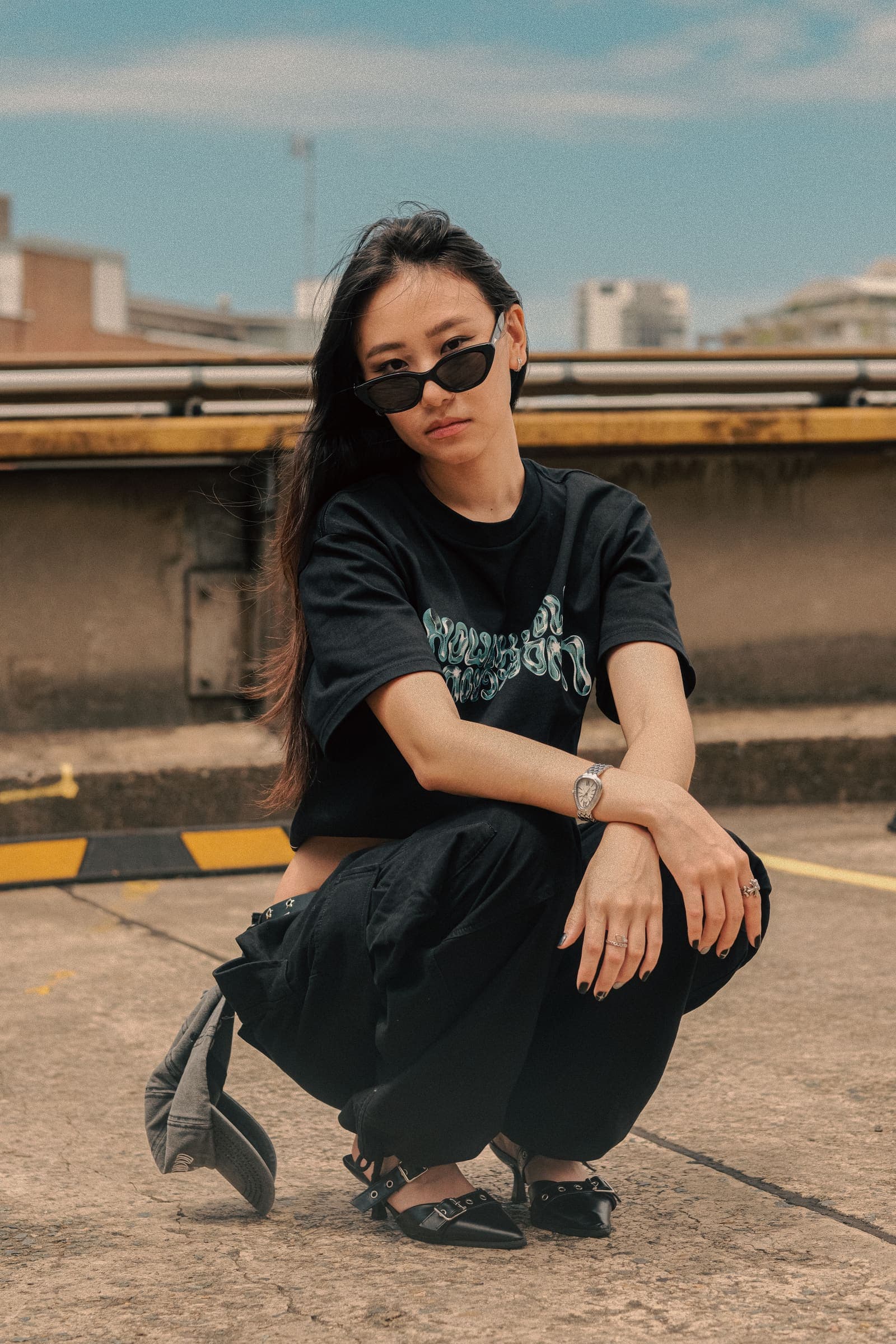 The same crouch on the rooftop, framed closer