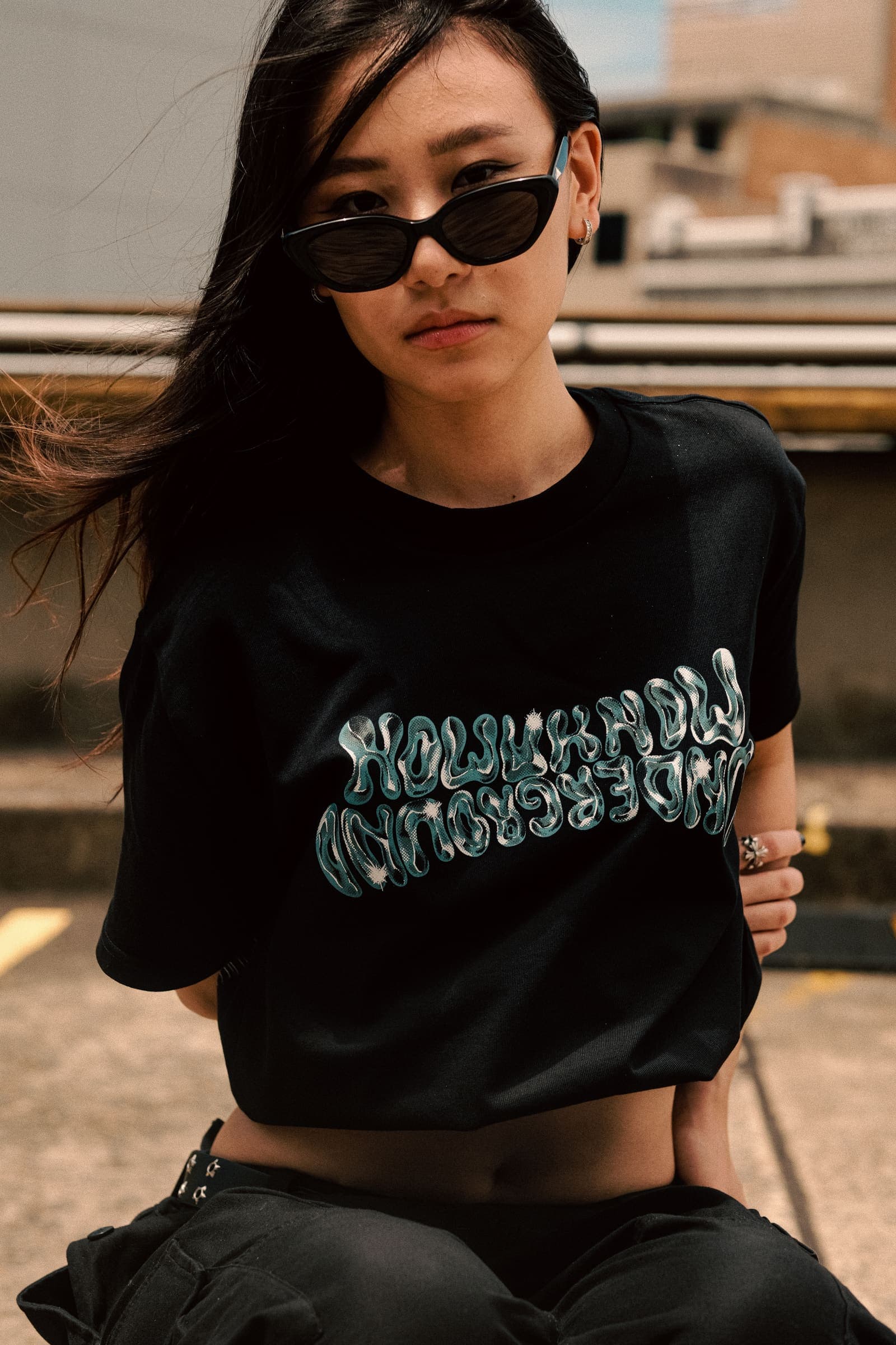 Close on the tee's liquid-chrome front print
