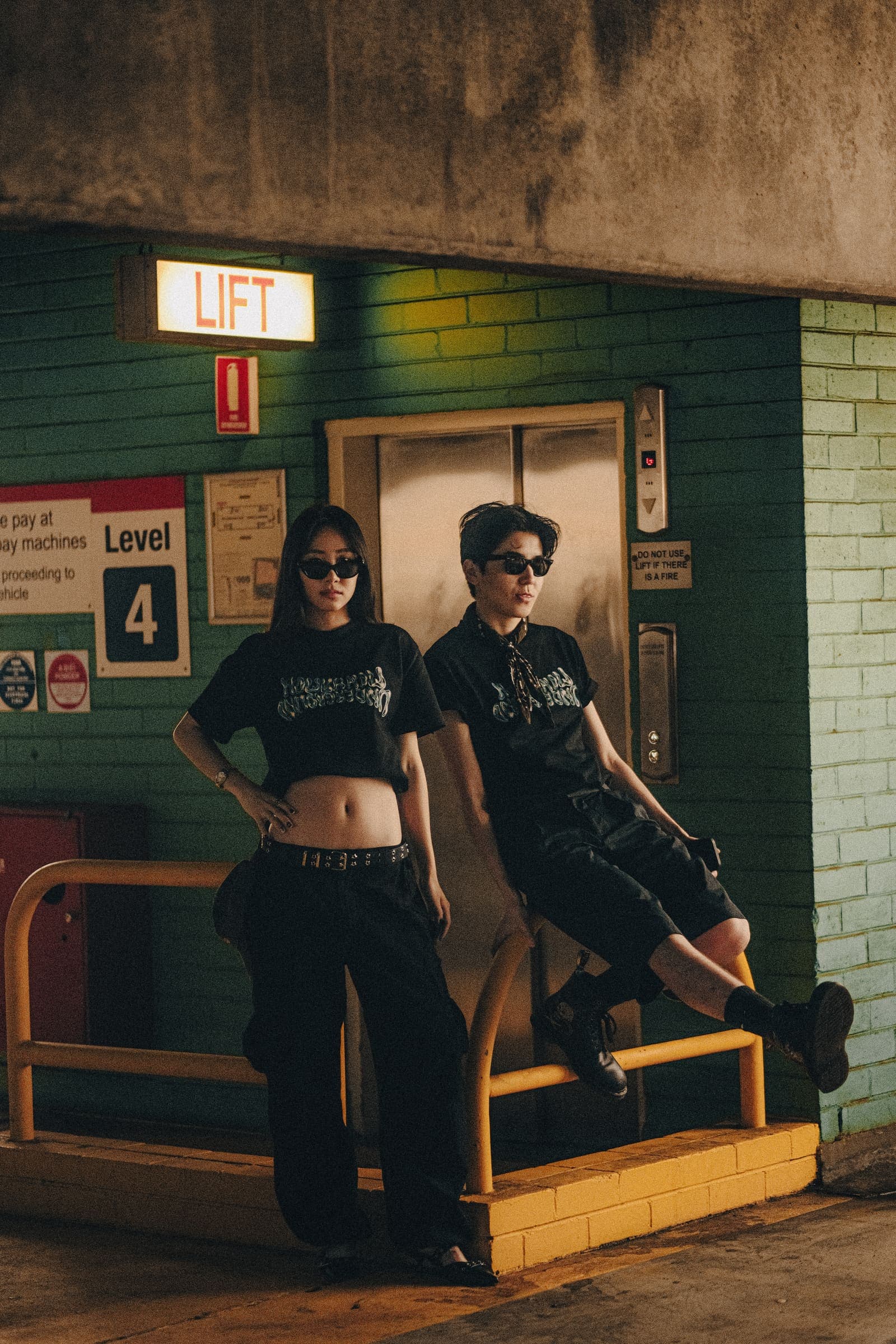 Two models by a car park lift on level 4