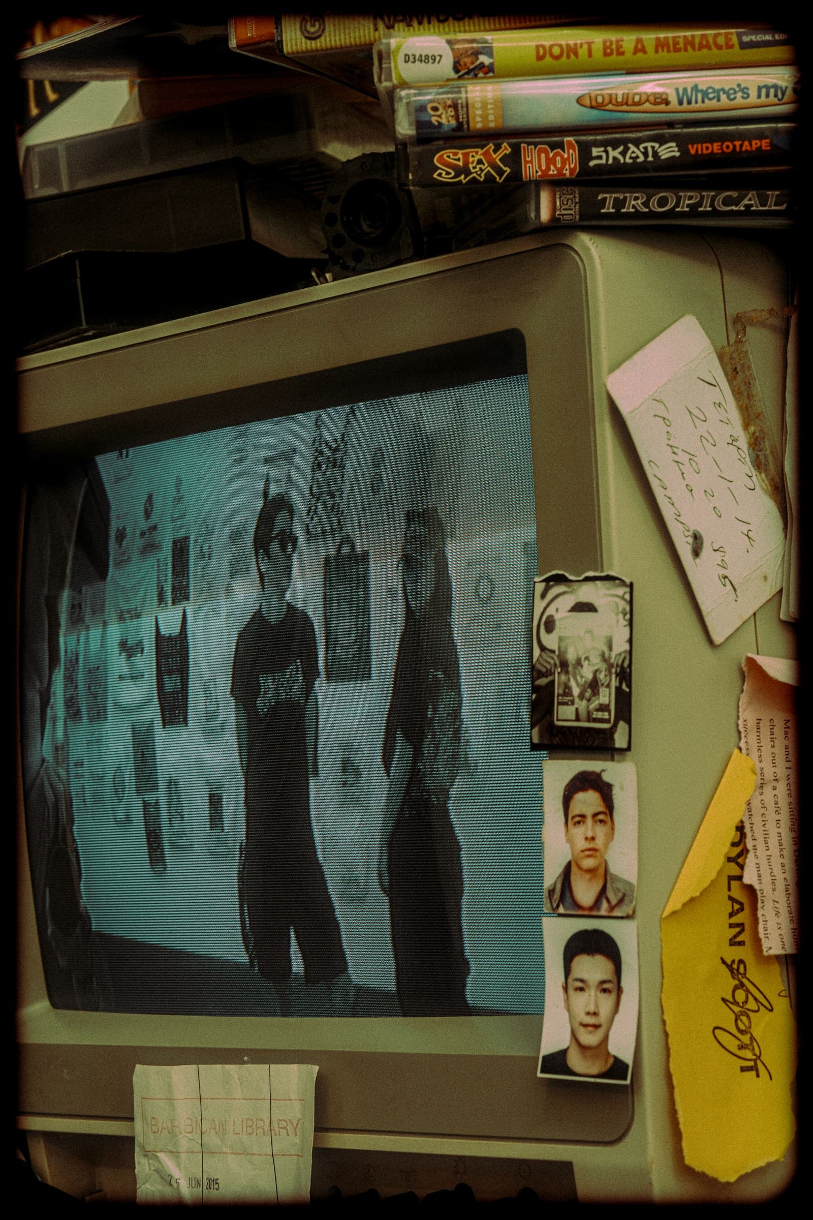 The pair on the screen of an old CRT television, among video tapes and stickers